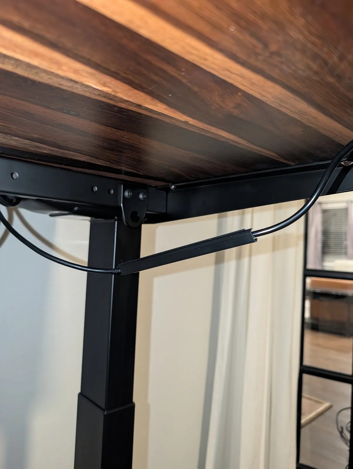 The small adhesive clip for the keypad cable come away from the underside of the desk, leaving the cable hanging in a loop.